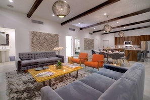 Open Plan Great Room with Exposed Beams and Globe Chandeliers