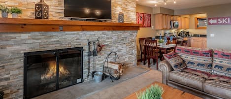 Relax in front of the stacked stone fire place. 