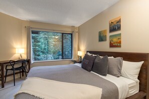 Secondary bedroom w/ king-sized bed and work desk