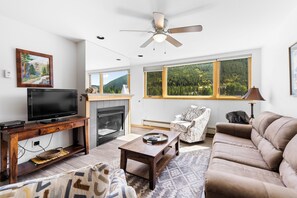 Living room featuring a flat screen TV and fireplace.