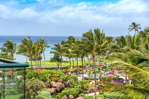 Tropical paradise unfolds below with palm-lined lawns, ocean views, and colorful cabanas along Maui?s scenic coastline HKH-442