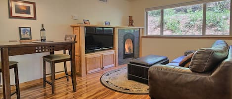 Cozy and romantic living room with 47-inch flatscreen and gas fireplace.