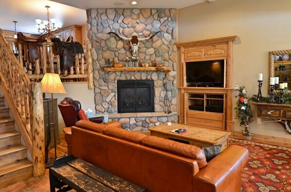 Spacious Living Room - Spacious living room with TV, fireplace, and gaming area.