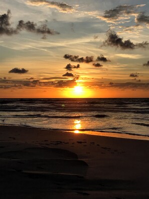 AN EARLY MORNING SUNRISE ILLUMINATES YOUR 
PRIVATE  BEACH