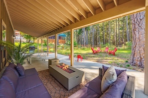 Covered Outdoor Sitting Area with a Gas Fire Table and Overhead Heaters to Enjoy Year Round