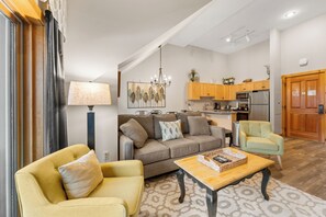 Living area with queen sleeper sofa, fireplace, and balcony access.