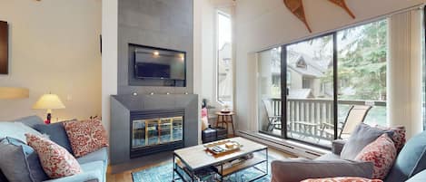 Sunken living area w/ a cozy wood-burning fireplace and cable tv