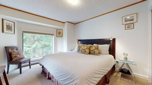 Primary bedroom w/ a King-sized bed