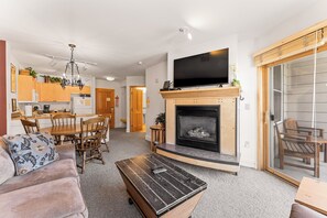 Living area with a gas fireplace, TV, and queen sleeper sofa.