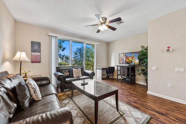 Spectacular Living area of the Townhouse in Orlando - Unwind in the comfort of our townhouse living area with cozy sofas - Stunningly located private balcony - Majestic decor with large size wall mirror and wall pintings