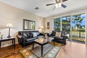 Spectacular Living area of the Townhouse in Orlando - Unwind in the comfort of our townhouse living area with cozy sofas - Stunningly located private balcony - Majestic decor with large size wall mirror and wall pintings