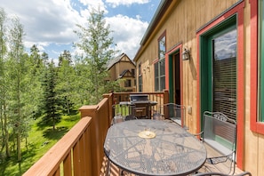 Private deck with a grill and outdoor seating.