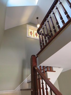 Stained glass window at the top of the stairs is shared with the large bathroom.