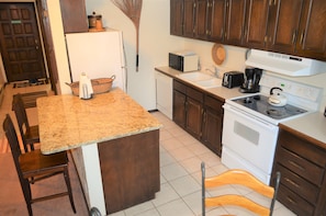 Fully Equipped Kitchen - Fully equipped kitchen with all necessary appliances, breakfast bar with extra seating, and a dining table big enough for the entire party.
