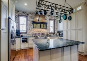 Dream Kitchen w/ commercial range / oven, soapstone countertops, excess storage.