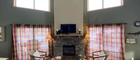 Main living room w/ beautiful views of Lake Granby. Kitchen/dining to the left