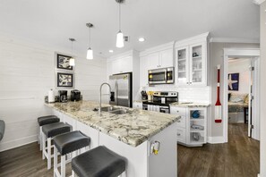 Kitchen with full size appliances and cooking essentials.