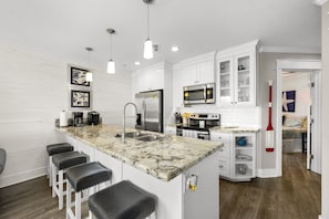 Kitchen with full size appliances and cooking essentials.