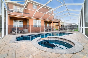 View of back of home from pool deck showing safety pool