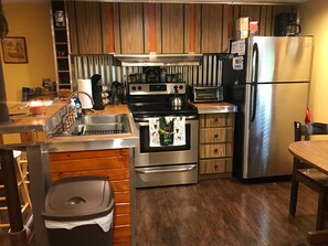 The full kitchen including a new oven, stove, and refrigerator!