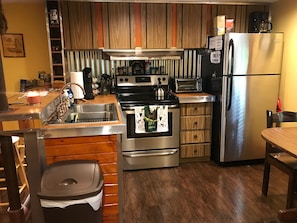 The full kitchen including a new oven, stove, and refrigerator!