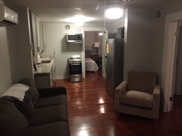 Den and kitchen with hardwood floors and open floor plan. 