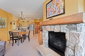 Living area featuring a beautiful gas fireplace, a flat screen TV and a queen-sized sleeper sofa.