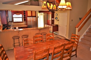Fully Equipped Kitchen and Dining Area - The fully equipped kitchen and dining room area open up to each other making the main level very spacious. The dining room area is very large, which makes it big enough for the entire party and guests.