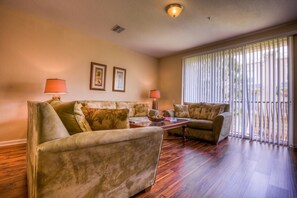 The impeccably furnished living room is the perfect place to gather together or simply relax as it offers a spacious, comfortable seating area.