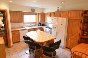 Fully-Equipped Kitchen - The fully-equipped kitchen has all the amenities needed. It also has a breakfast bar with chairs for extra seating.