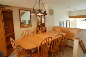 Dining Room - The dining room has a table large enough for the entire party. It opens into a fully equipped kitchen with extra chairs at the breakfast bar.