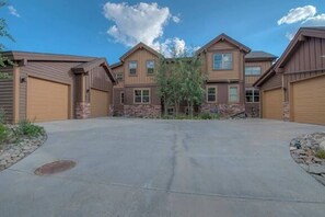 Townhome exterior: On-site parking for 4 vehicles (2 in garage, 2 in shared driveway)
