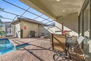Private pool with a BBQ grill and a outdoor dining area