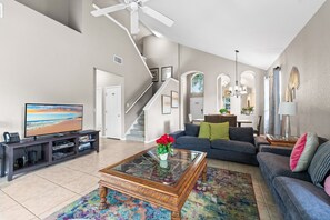 Get cozy with your loved ones after a long day at the parks. This living room has sofa seating, large SMART TV, and a ceiling fan.