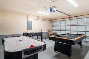 Garage converted into a games room area with foosball, pool and air hockey tables for some added fun.