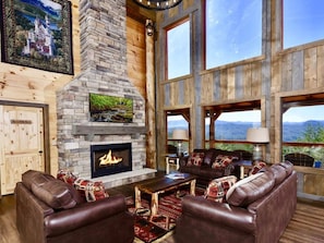 The main floor has a large 2 story great room with a massive fireplace and TV