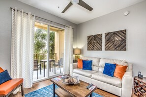 Inviting living area of the condo in Orlando where comfort meets style. - Majestically decored space with beautiful wall paintings - Relax on comfy sofas after a day full of adventure - Magnificent balcony facing living area with views