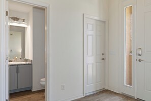 Half bathroom and entrance to garage of Cobia