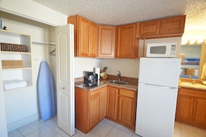 Kitchenette includes full fridge, microwave, stove top, coffee maker and kitchenware