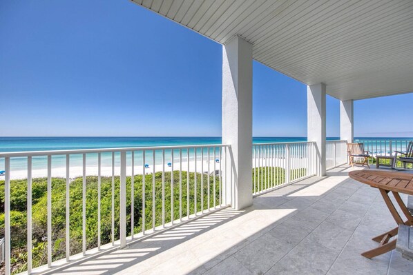 Covered balcony with seating to enjoy your morning coffee or evening nightcap