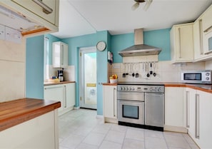 The modern and well equipped kitchen has a useful utility area which leads onto the terrace