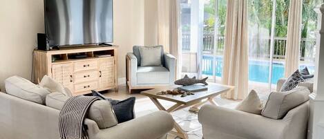 Living Room with Vaulted Ceilings opening to the pool and waterfront.