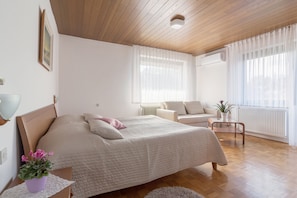 A large king size bed (180 x 200 cm) and a three-seat sofa in the first bedroom.