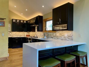 Beautiful, well stocked kitchen w/lots of counter space, quartz counters.