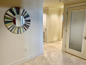 This is the foyer, facing the locked door that leads downstairs. It also leads to the kitchen straight ahead. The Master is to the left and the guest bedroom is to the right.
