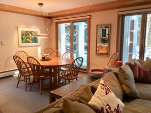 Living/dining area with sliding glass door, garden entrance