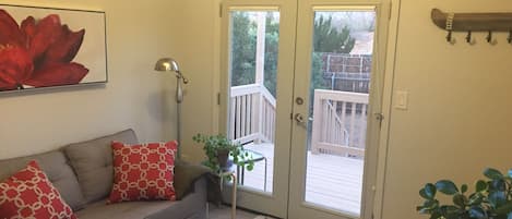 Sitting room with pull-out couch, dining table and kitchenette.