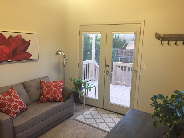 Sitting room with pull-out couch, dining table and kitchenette.