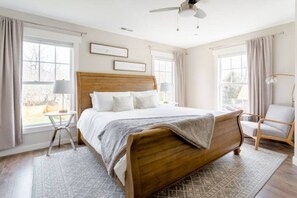 King sized bed in the primary bedroom with luxurious linens.