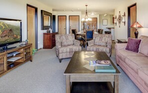 Living room featuring coffee table and comfortable chairs and couch.